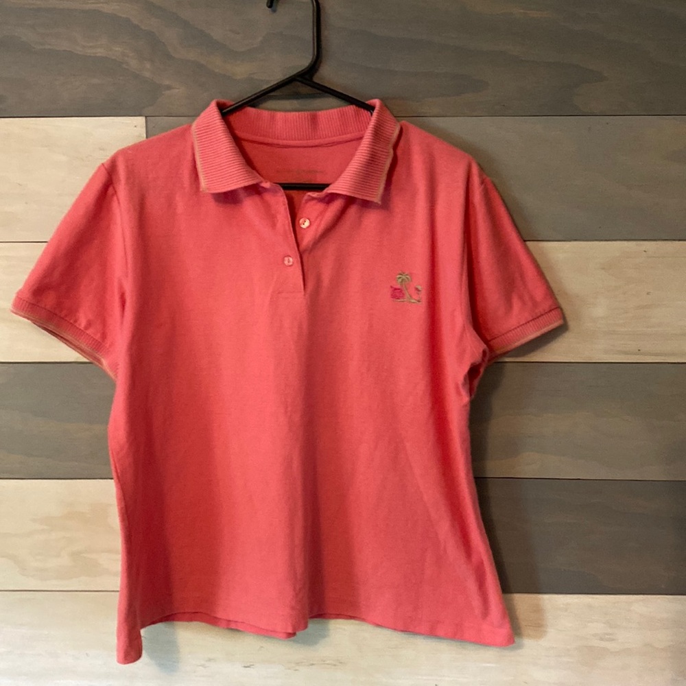 Woman’s golf shirt in A shade of coral.  name  has worn off. L
